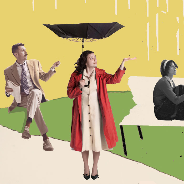 women in bright coat holding umbrella